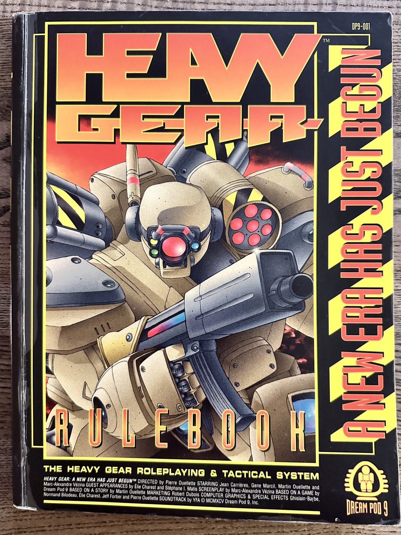 Heavy Gear roleplaying game rulebook, 1995. It depicts a close-up of a grey giant robot brandishing a rifle.